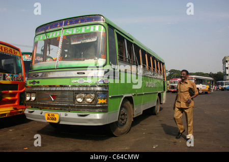 Conductor boards private Express bus departing from bus station in Thrissur Kerala India Stock Photo