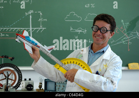 Funny school teacher explaining motorized flight with model plane Stock Photo