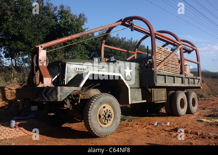 Veteran US Army 6x4 truck abandoned during the Laos secret war in the 1970s now used by Laotian traveling community Stock Photo