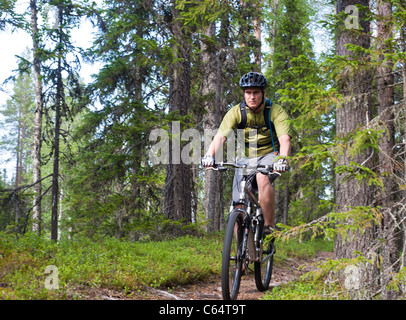A male mountain biker riding in Isosyote, Pudasjarvi, Finland. Stock Photo