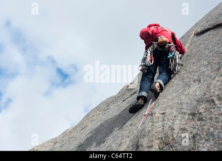 A male rock climber climbing in traditional style in Lofoten Islands, Norway Stock Photo