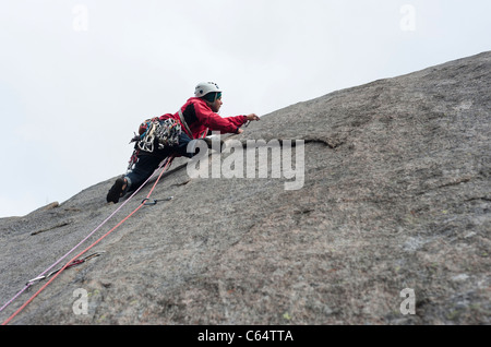 A male rock climber climbing in traditional style in Lofoten Islands, Norway Stock Photo