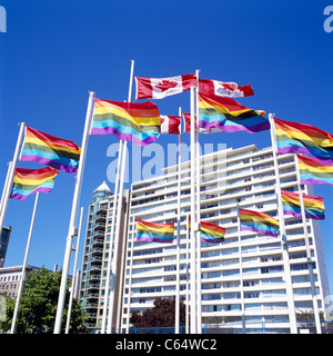 Vancouver, BC, British Columbia, Canada - Gay Pride Rainbow Flag and Canadian Flags blowing in Wind, West End of City Stock Photo
