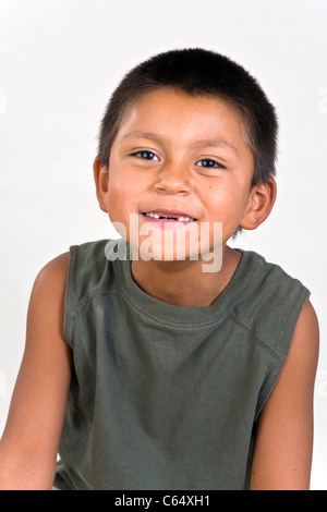 Happy 6-7 year old Hispanic boy with missing two front teeth. MR © Myrleen Pearson Stock Photo