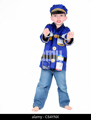 Young boy in police costume with handcuffs on white background Stock Photo