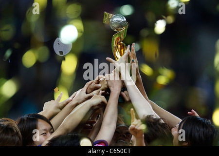 Japanese players hoist the World Cup trophy after defeating the USA to win the FIFA Women's World Cup final July 17, 2011. Stock Photo