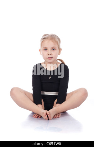 Gymnast girl sitting in butterfly pose isolated on white Stock Photo