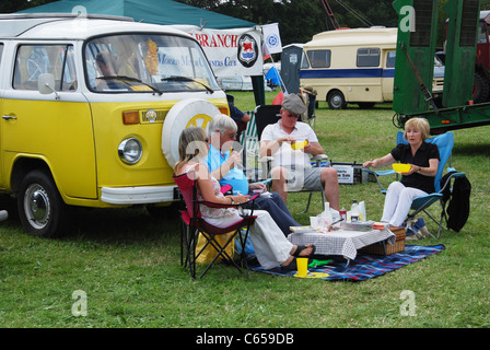 VW T2B bus and enthusiasts gathered together at classic car meeting  United Kingdom Stock Photo