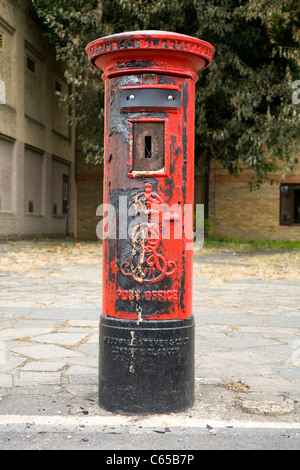 Vandalised Type 'B' pillar box / post / letter box, set fire to / burned / burnt during Croydon riot / riots, London. UK. Stock Photo