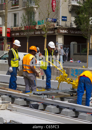Paris, France, Construction Site, Small Group of Men Working on T3 Tramway on Street, Hard hats, construction site train france Stock Photo