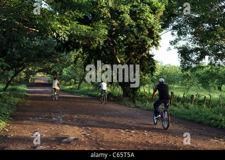 Cyclists on the main road at Playa Santo Domingo Stock Photo