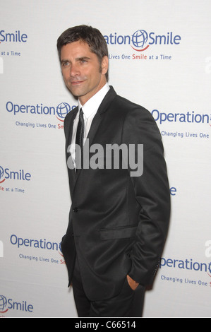 John Stamos at arrivals for Operation Smile's 9th Annual Smile Gala, Beverly Hilton Hotel, Beverly Hills, CA September 24, 2010. Photo By: Michael Germana/Everett Collection Stock Photo