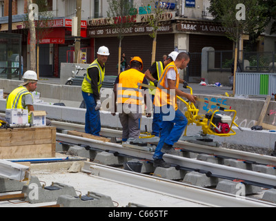 Paris, France, Small Group People, Construction Workers African Immigrants, Installing Train Tracks on Street for Tram, International Immigrants Europe, immigrant labor, black community Paris, immigrant worker france, labourers, workplace diversity Stock Photo