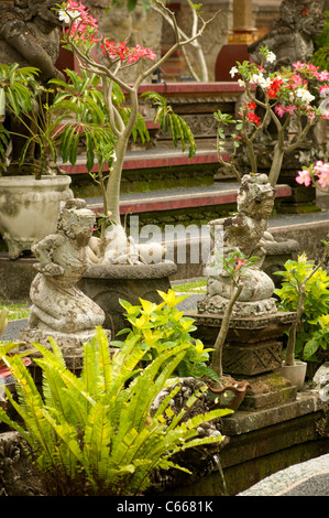 Statues and bonsai trees at Balinese Hindu Temple Stock Photo