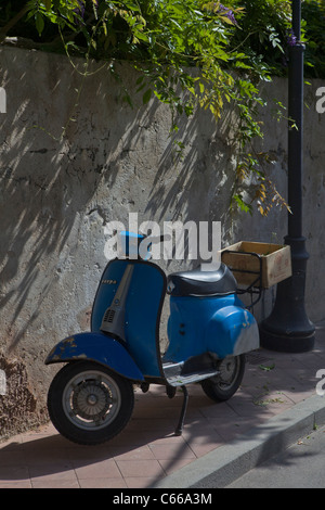 Vintage blue Vespa scooter parked somewhere in Sicily - Mediterranean coast, Italy, Europe. Stock Photo