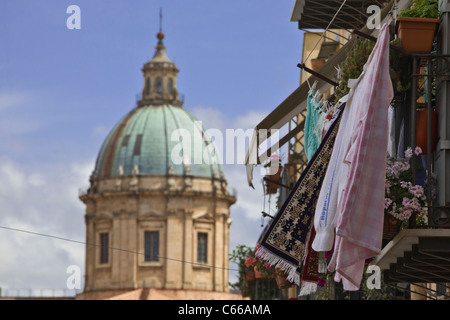 Linen, clothes and flowers on balcony and cathedral of Palermo (Duomo) in background. Palermo, Sicily, Italy, Europe, EU Stock Photo