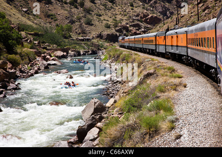 Popular tourist train runs through the 1,000' deep Royal Gorge Route along the Arkansas River, Central Colorado, USA Stock Photo