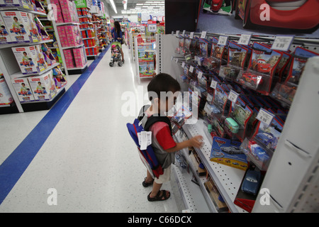 Little boy with his new backpack in Toys r us store before new school year Stock Photo