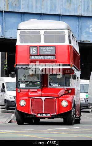 Front view of London Transport public transport red double decker classic historical Routemaster bus & driver in cab on route 15 the heritage route UK Stock Photo