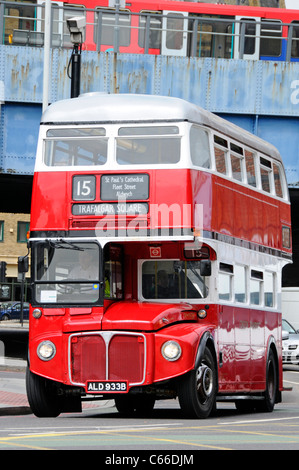 Front view of London Transport public transport red double decker classic historical Routemaster bus & driver in cab on route 15 the heritage route UK Stock Photo
