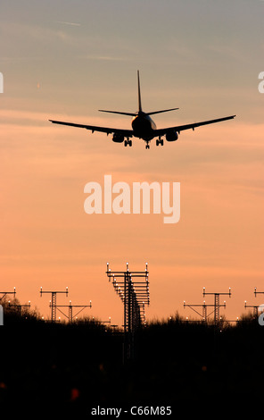Plane passing navigation beacons on the approach to London Luton airport Stock Photo