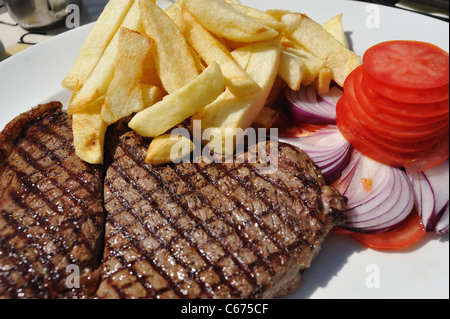 Steak chips onions and tomatoes Stock Photo