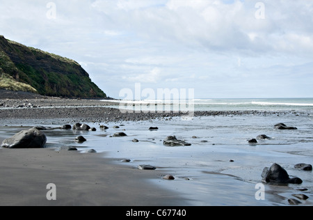 The Black Volcanic Beach and Rocky Shore on the South Taranaki Bight by Kaupoxonui Manaia North Island New Zealand NZ Stock Photo