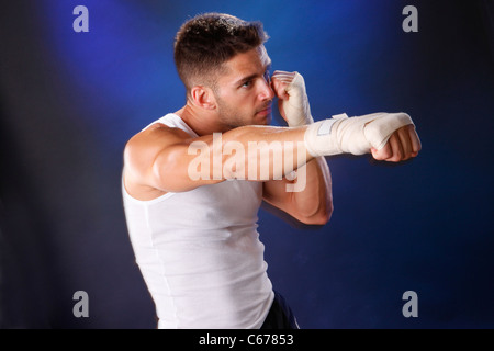 Toned boxer workng with hand wraps Stock Photo