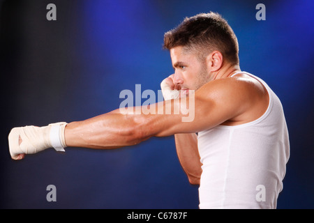 Toned boxer workng with hand wraps Stock Photo