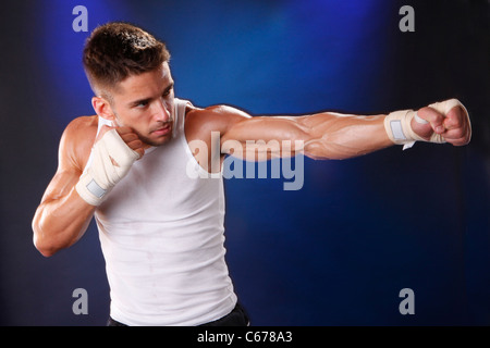 Toned boxer workng with hand wraps Stock Photo