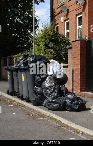 Full wheelie bins overdue for rubbish collection Stock Photo