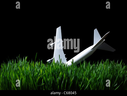 Toy Airplane in grass at night Stock Photo