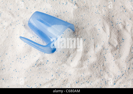Laundry detergent powder for washing machine and plastic scoop for dosage. Stock Photo