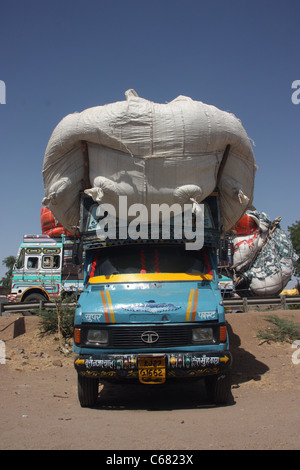 Heavily overloaded truck carrying crop parked in the desert near Kota Rajasthan Stock Photo