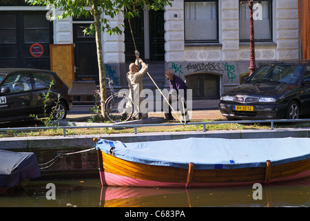 Traditional way of lifting furniture upstairs in Amsterdam - lifting with single pulley Stock Photo