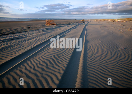 Tire tracks in the sand on the beach. Waitarere Beach, Horowhenua, Wellington, New Zealand, Australasia Stock Photo