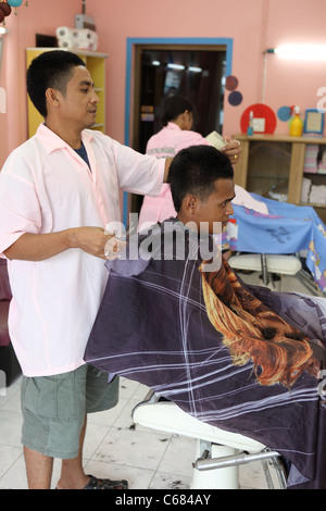 Man having his hair cut at a salon. Stock Photo