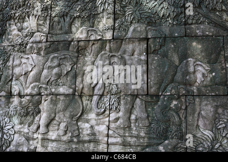 Elephant herd sculpture on stone wall at Phuket zoo. Stock Photo