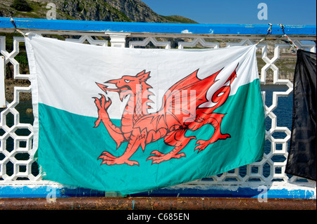 Welsh flag hanging on the railings of Llandudno Pier Stock Photo