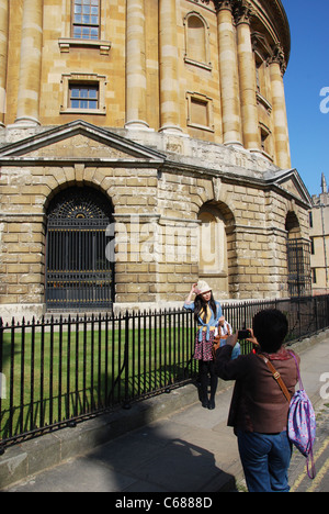 posing in front of Radcliffe Camera Oxford United Kingdom Stock Photo