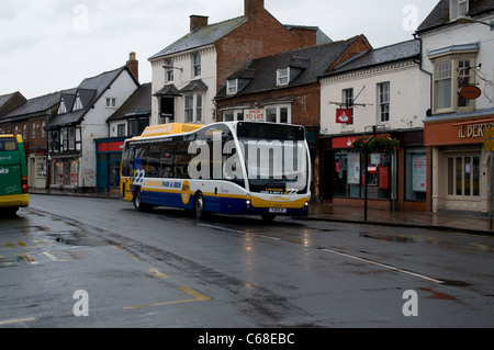 A new Diesel-Electric Hybrid bus operated by Johnsons passes the old buildings of Stratford-upon-Avon working on Park & Ride Stock Photo