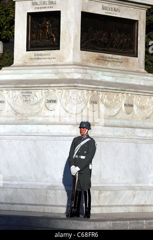 Young soldier stands guard in front of Monumento O'Higgins in the Plaza de Cultura. Stock Photo