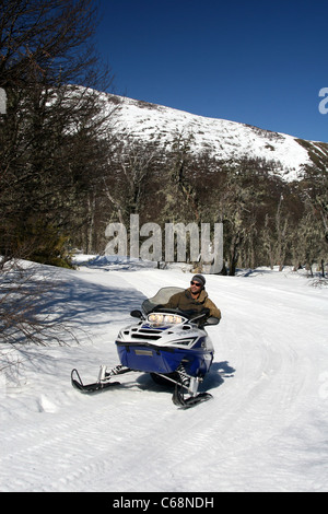 Man having fun on the snowmobile circuit at Termas de Chillan ski resort. Biobio, Chile, South America Stock Photo