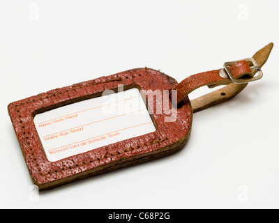 alter Kofferanhänger auf weißem Hintergrund | old luggage label on white background Stock Photo