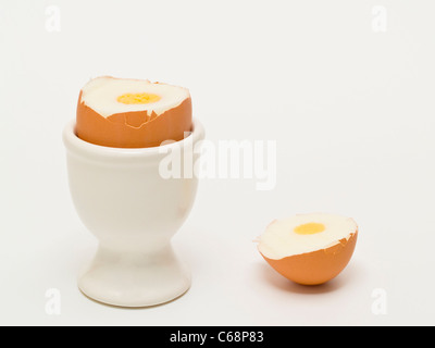 ein geköpftes Hühnerei steht im Eierbecher | one beheaded hen's egg in a eggcup Stock Photo
