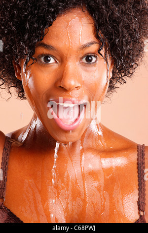 Cute African American with water dripping through her face Stock Photo