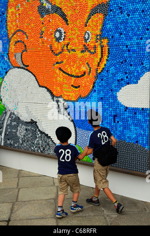 Two school boys looking at a mural painting mosaic (Japan Committee for Vaccines JCV - World´s Children Polio), Kyoto, Japan JP Stock Photo