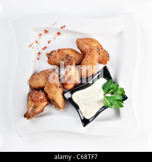 Fried chicken wings with sauce isolated on white by clipping path Stock Photo