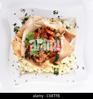 hot spicy salad of fried pork cuts, chicken fillet, paprika and string beans Stock Photo