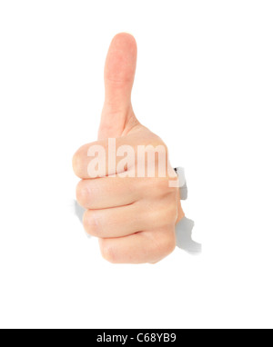 Hand showing thumb up out of torn hole in white wall. All on white background. Stock Photo